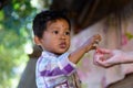 A child take a snack from tourist, Cambodia