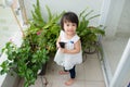 Child taking care of plants. Cute little girl watering first spring flowers Royalty Free Stock Photo