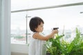 Child taking care of plants. Cute little girl watering first spring flowers Royalty Free Stock Photo