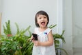 Child taking care of plants. Cute little girl watering first spring flowers Royalty Free Stock Photo