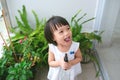 Child taking care of plants. Cute little girl watering first spring flowers Royalty Free Stock Photo