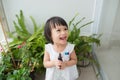 Child taking care of plants. Cute little girl watering first spring flowers Royalty Free Stock Photo