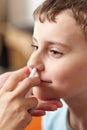 Child taking a dose of nasal spray Royalty Free Stock Photo