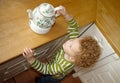 Child taking Teapot Royalty Free Stock Photo