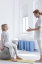 Child talking with friendly physiotherapist Royalty Free Stock Photo