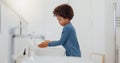 Child, tap and washing or cleaning hands for hygiene, bacteria or germ removal in sink at home. Little boy or kid Royalty Free Stock Photo