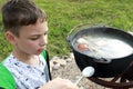 Child tastes fish soup