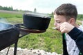 Child tastes russian fish soup