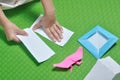 Child tear paper to make origami paper craft