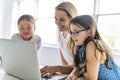 Child with technology tablet and laptop computer in classroom teacher on the background Royalty Free Stock Photo