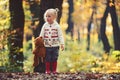 Child with teddy bear in fairy tale woods. Little girl in autumn forest. Kid with toy enjoy fresh air outdoor. Childhood Royalty Free Stock Photo