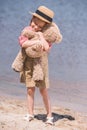 Child with teddy bear at seashore Royalty Free Stock Photo