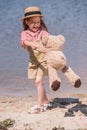 Child with teddy bear at seashore Royalty Free Stock Photo
