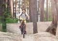 Child teenager in white t shirt and yellow shorts on bicycle ride in forest at spring or summer. Happy smiling Boy cycling outdoor