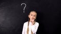 Child thinking about hometask solution, question mark on blackboard background