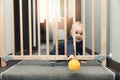 child throwing ball away through safety gates in front of stairs Royalty Free Stock Photo