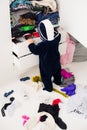 Child throws clothes Royalty Free Stock Photo
