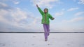 A child throws dust on a dry salt lake. Royalty Free Stock Photo