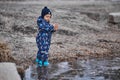 a child throws stones into the water