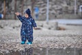 a child throws stones into the water