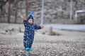 a child throws stones into the water