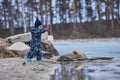 a child throws stones into the water