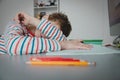 Child tired and bored of doing homework, kid stressed from learning indoors Royalty Free Stock Photo