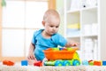 Child toddler playing wooden toys at home Royalty Free Stock Photo