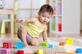 Child toddler playing wooden toys at home Royalty Free Stock Photo