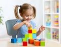 Child toddler playing wooden toys at home Royalty Free Stock Photo