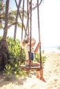 Child toddler swing beach during summer vacation concept happy childhood travel lifestyle Royalty Free Stock Photo