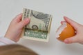 A on a white background, the child took a dollar in an egg shel Royalty Free Stock Photo