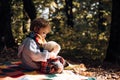 Child took favorite toy to nature. Picnic with teddy bear. Hiking with favorite toy. Better together. Happy childhood
