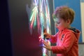 Child touching glowing map