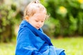 Child in towel after swimming basking in sun on tropical resort Royalty Free Stock Photo