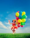 Child with toy balloons in spring field Royalty Free Stock Photo