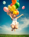 Child with toy balloons in spring field Royalty Free Stock Photo