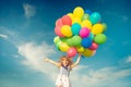 Child with toy balloons in spring field Royalty Free Stock Photo