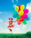 Child with toy balloons in spring field Royalty Free Stock Photo