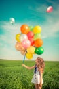 Child with toy balloons in spring field Royalty Free Stock Photo