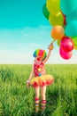 Child with toy balloons in spring field Royalty Free Stock Photo