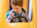 Child on a toy car. The car is yellow. child 0-1 year old Royalty Free Stock Photo