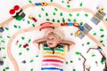 Child with toy train. Kids wooden railway. Royalty Free Stock Photo