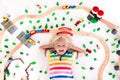 Child with toy train. Kids wooden railway. Royalty Free Stock Photo