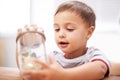 Child, toys and jar for playing for development, growth curiosity and young boy. Kid, animals and game or learning Royalty Free Stock Photo