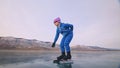 The child train on ice professional speed skating. The girl skates in the winter in sportswear, sport glasses, suit