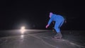 The child train on ice speed skating. The night skating. The girl skates in the winter in sportswear, sport glasses