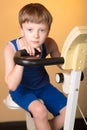 The child is trained on a stationary bike . Healthy lifestyle. Royalty Free Stock Photo