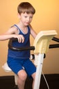 The child is trained on a stationary bike . Healthy lifestyle. Royalty Free Stock Photo