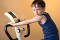 The child is trained on a stationary bike . Healthy lifestyle. Royalty Free Stock Photo